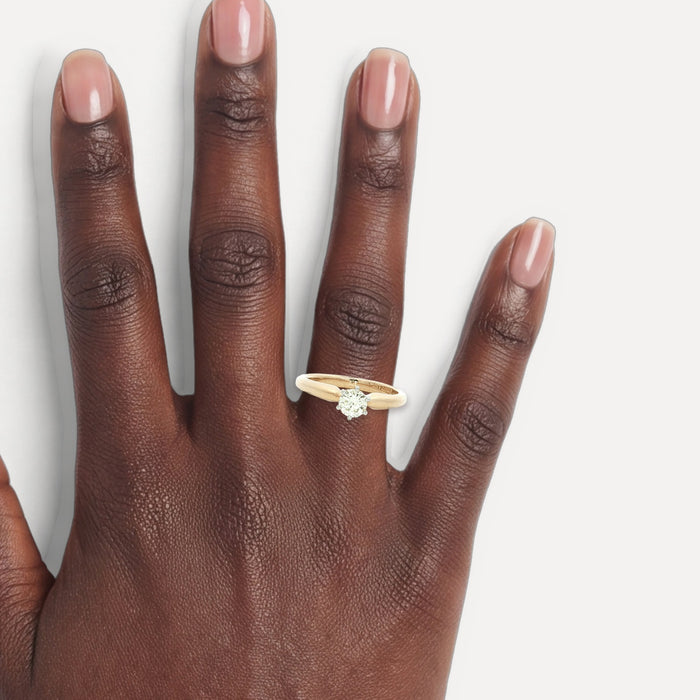 Round Brilliant Cut Solitaire Engagement Ring (⅖ ct.) in 14k Yellow Gold shown on a hand (deep skin tone)