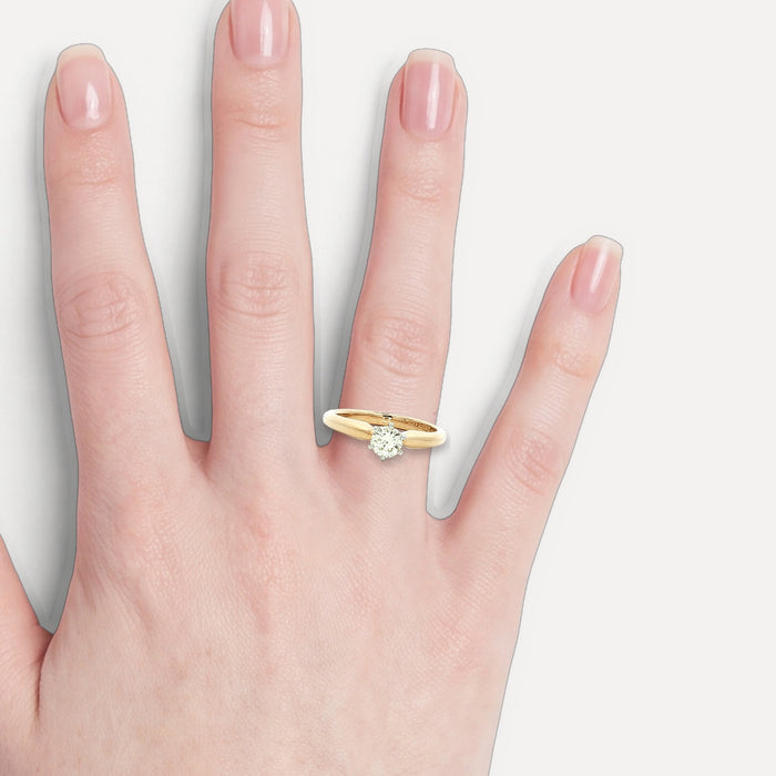 Round Brilliant Cut Solitaire Engagement Ring (⅖ ct.) in 14k Yellow Gold shown on a hand (light skin tone)