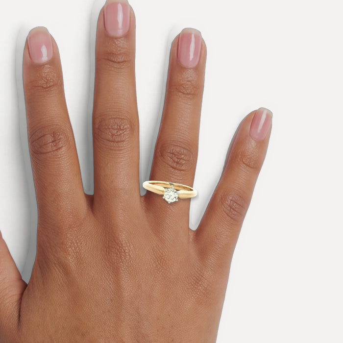 Round Brilliant Cut Solitaire Engagement Ring (⅖ ct.) in 14k Yellow Gold shown on a hand (medium deep skin tone)