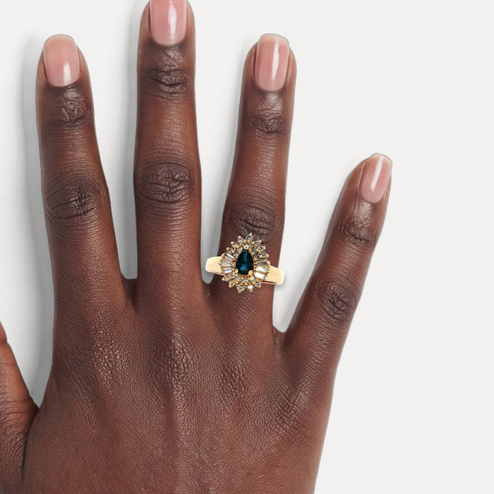 Pear-Shaped Sapphire & Near-Colorless Diamond Ballerina Cocktail Ring (1 ½ ct. tw.) in 14k Yellow Gold shown on a hand (deep skin tone)