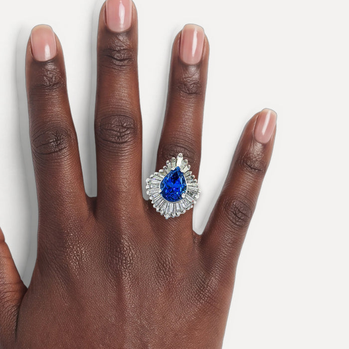 GIA Certified Pear Sapphire Colorless Diamond Ballerina Ring (7 ⅓ ct. tw.) in 14k White Gold shown on a hand (deep skin tone)