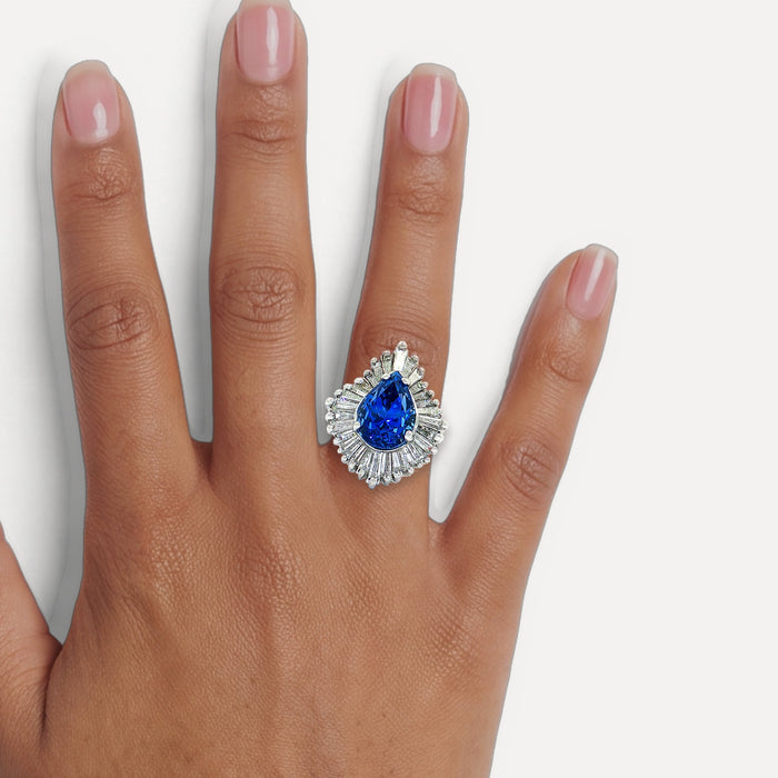 GIA Certified Pear Sapphire Colorless Diamond Ballerina Ring (7 ⅓ ct. tw.) in 14k White Gold shown on a hand (medium deep skin tone)
