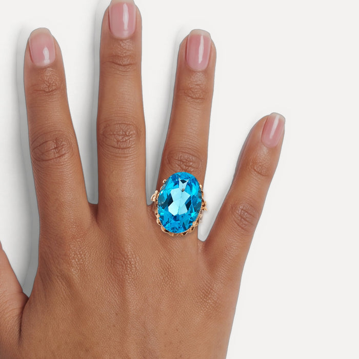 Vintage Oval-Shaped London Blue Topaz Ring (17 ct.) in 14k Rose Gold shown on a hand (medium deep skin tone)
