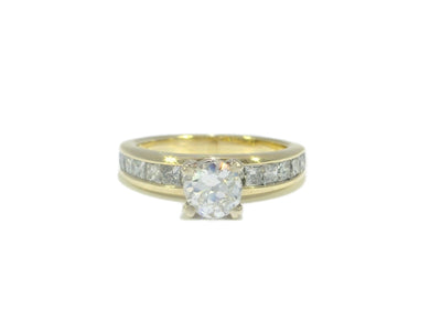 Gold ring with a diamond on a white background