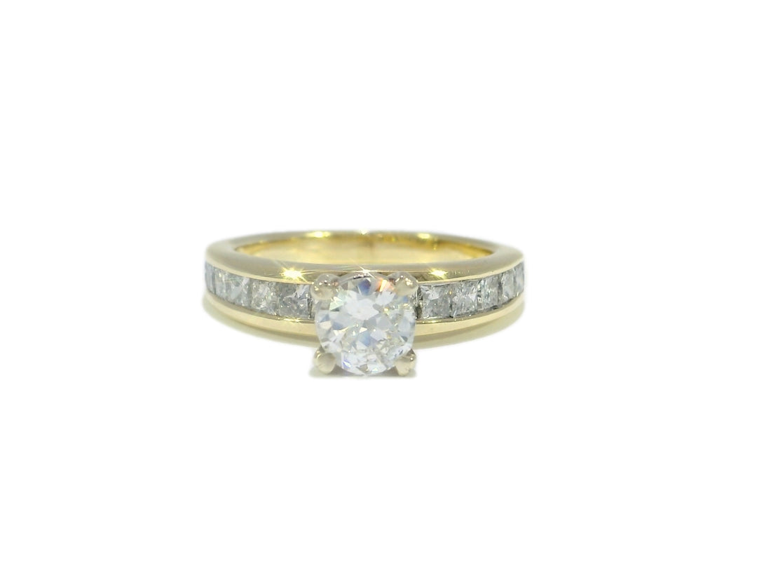 Gold ring with a diamond on a white background