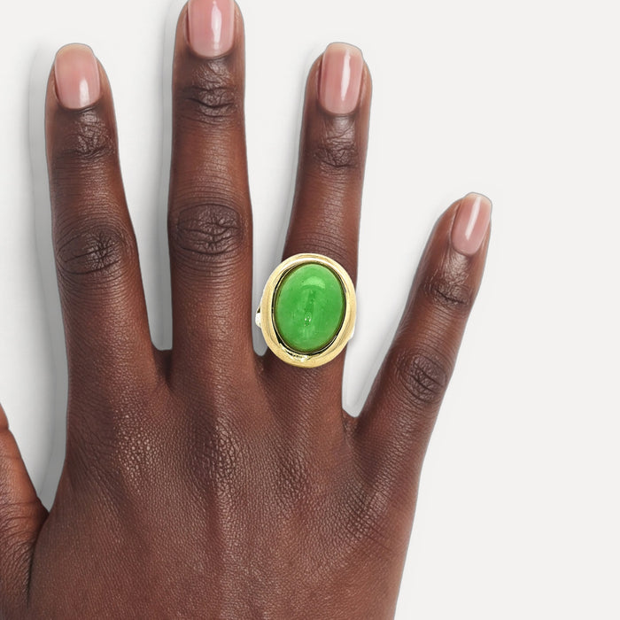 Oval Cabochon Jade Bezel-Set Ring (8 ⅓ ct.) in 14k Yellow Gold shown on a hand (deep skin tone)