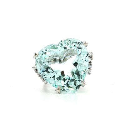 Heart-shaped turquoise gemstone ring with diamond accents on a white background