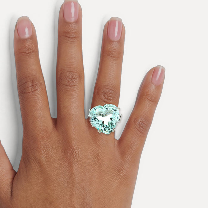 GIA Certified Heart-Shaped Vivid Aquamarine & Diamond Ring (25 ½ ct. tw.) in Platinum shown on a hand (medium deep skin tone)