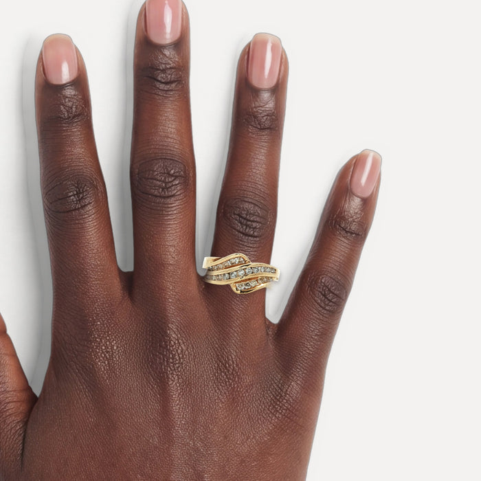 Near-Colorless Round Brilliant Cut Diamond Channel-Set Ring (⅗ ct.) in 14k Yellow Gold Wave shown on a hand (deep skin tone)