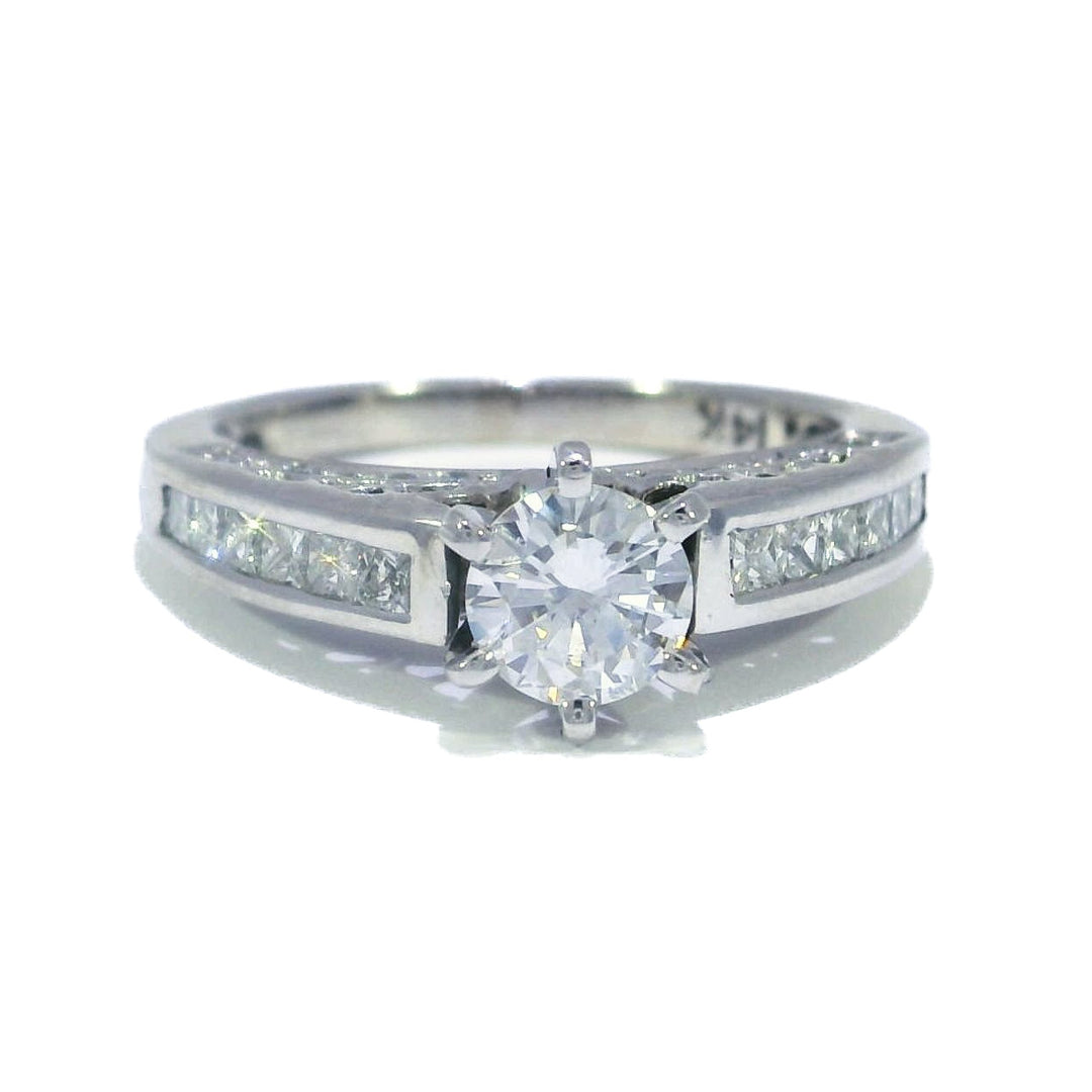 A round brilliant diamond engagement ring with white gold band and accents.
