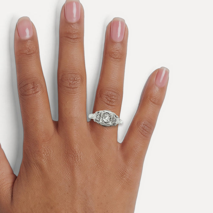 Vintage Nearly Flawless Colorless Diamond Ring (¼ ct.) in 18k White Gold shown on a hand (medium deep skin tone)