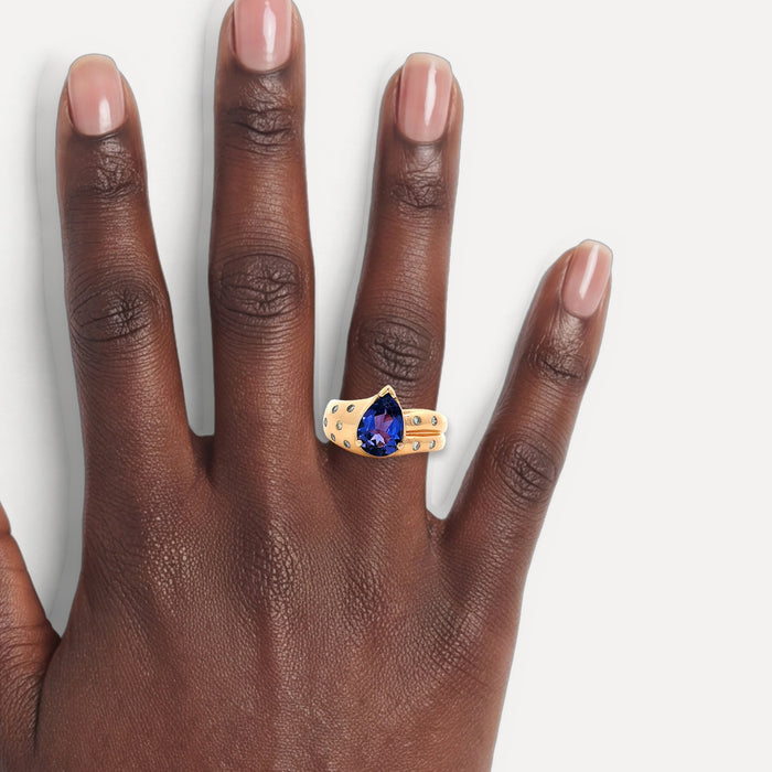 Vivid Pear Tanzanite Colorless Nearly Flawless Diamond Ring (3 ct. tw.) in 18k Rose Gold shown on a hand (deep skin tone)