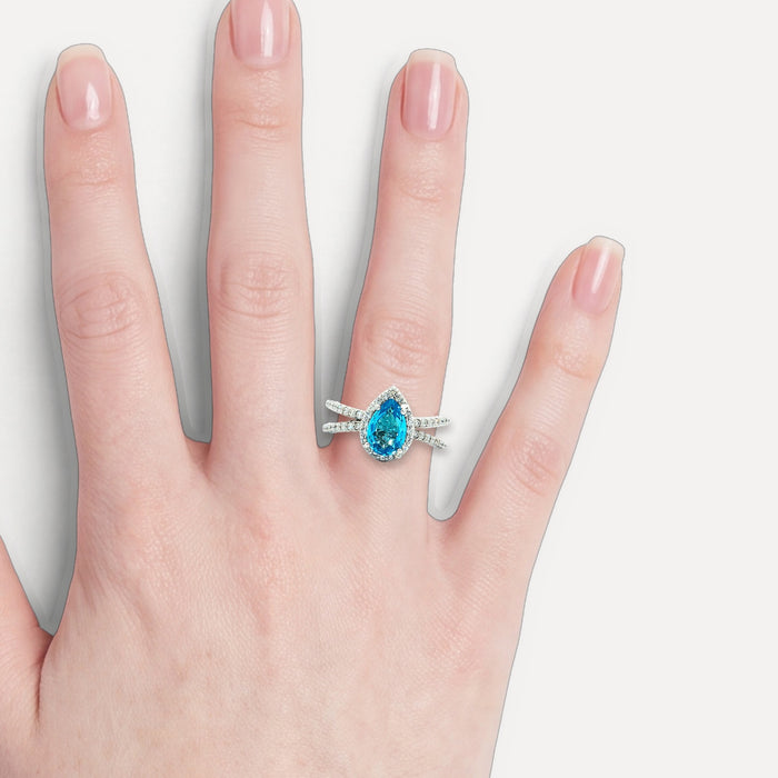 Pear-Shaped London Blue Topaz & Colorless Diamond Halo Ring (2 ½ ct. tw.) in 14k White Gold shown on a hand (light skin tone)