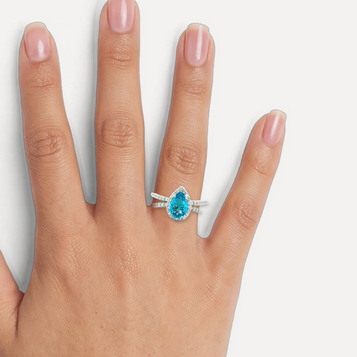 Pear-Shaped London Blue Topaz & Colorless Diamond Halo Ring (2 ½ ct. tw.) in 14k White Gold shown on a hand (medium skin tone)