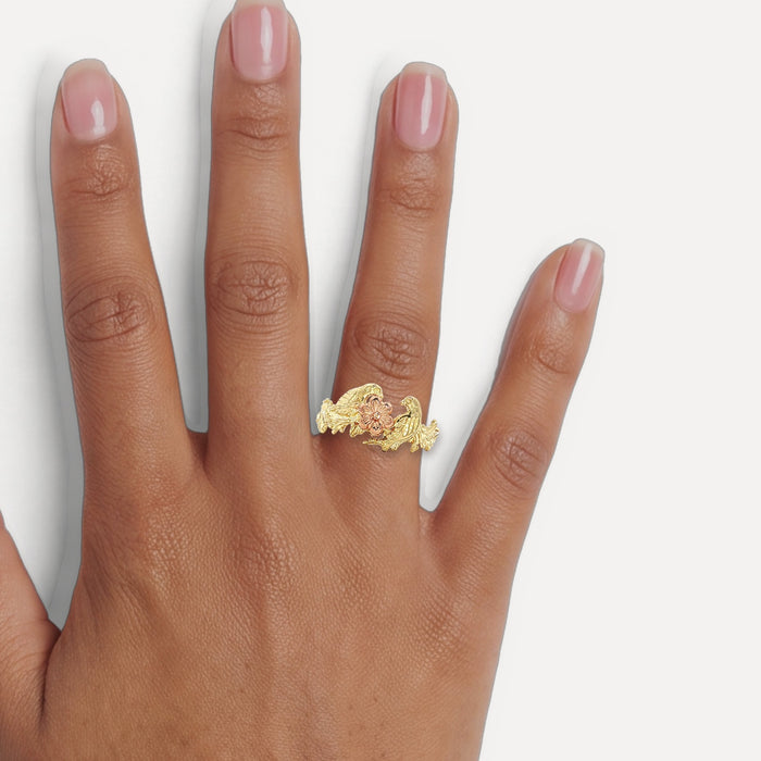 Vintage Black Hills Gold Grape Leaf & Bird Ring in 14k Two-Tone Yellow and Rose Gold shown on a hand (medium deep skin tone)