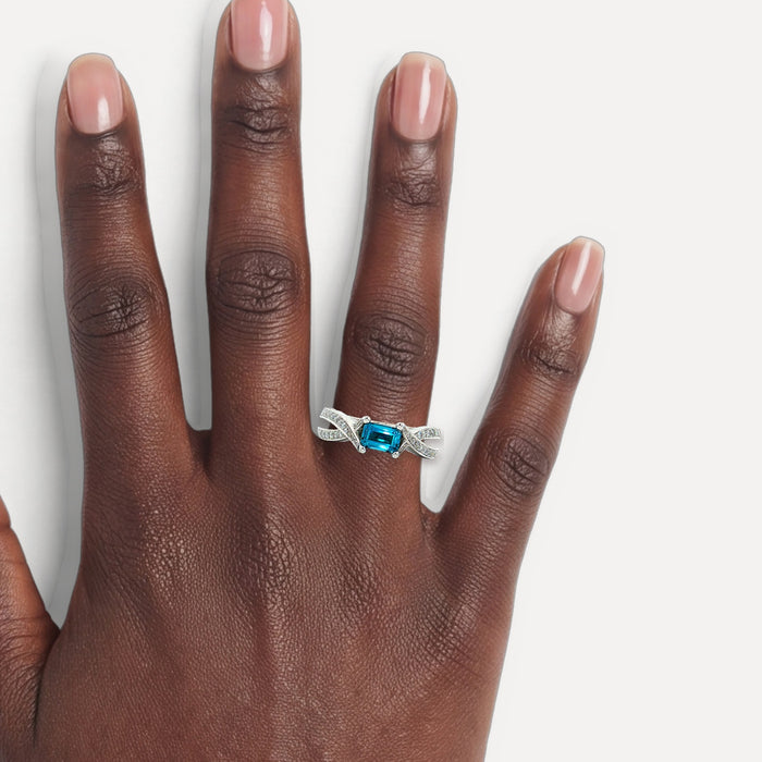 East-West Vivid Emerald-Cut Blue Spinel Diamond Ring (1 ½ ct. tw.) in 18k White Gold shown on a hand (deep skin tone)