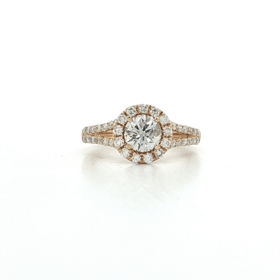 Round halo diamond engagement ring with split shank and pavé diamonds in yellow gold