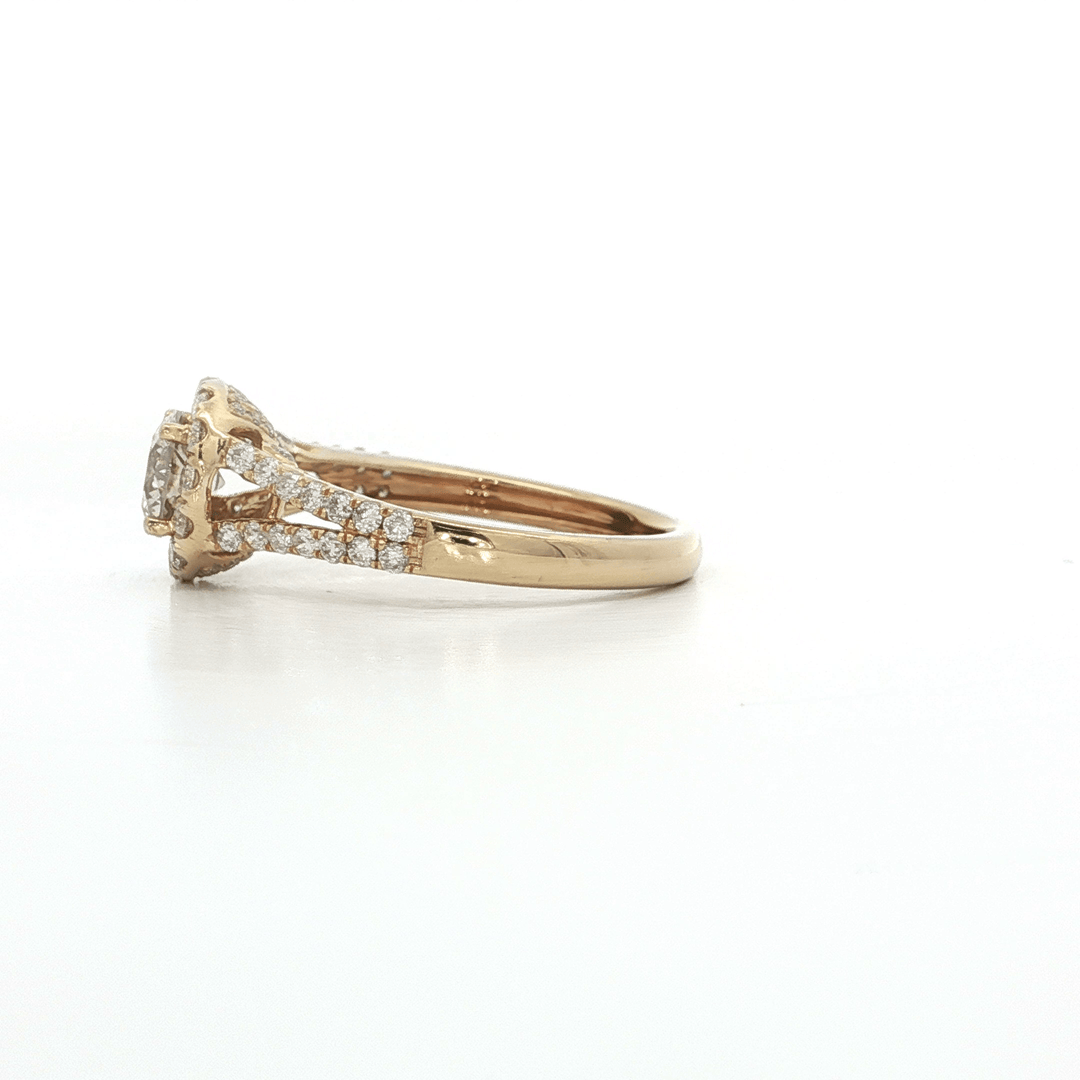 Yellow gold engagement ring with pavé-set diamonds on band and halo setting