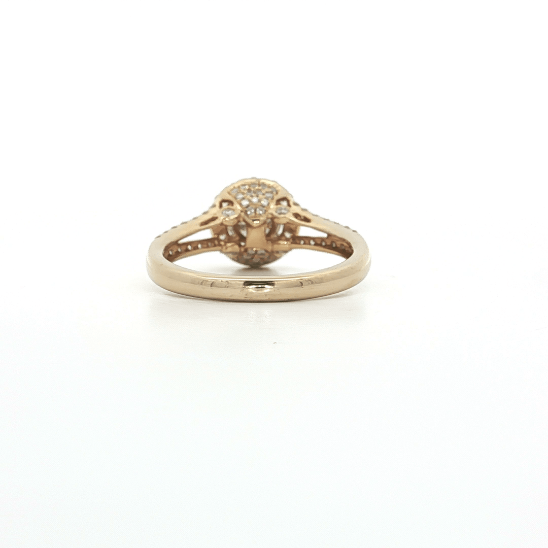 Rose gold diamond engagement ring with cluster setting on white background