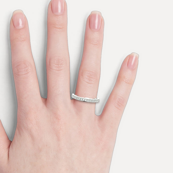 Round Brilliant Cut Colorless Diamond Wedding Band (⅕ ct.) in 18k White Gold shown on a hand (light skin tone)