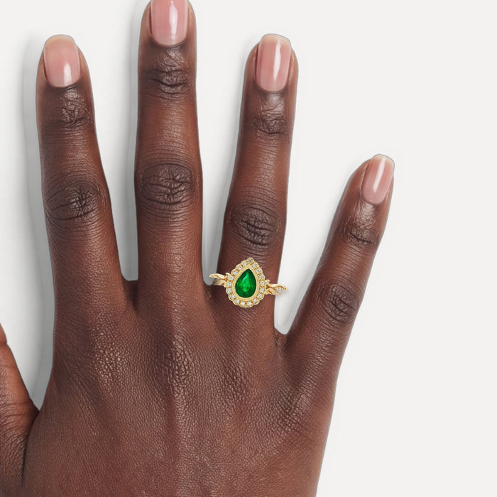 Pear Vivid Emerald & Diamond Halo Ring (1 ct. tw.) in 14k Yellow Gold shown on a hand (deep skin tone)