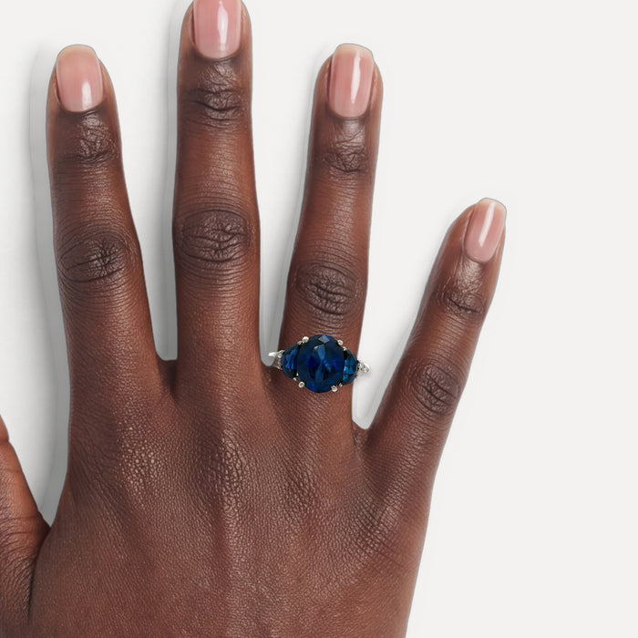 Moon Phase Sapphire Colored CZ Triple-Stone Ring in Sterling Silver shown on a hand (deep skin tone)