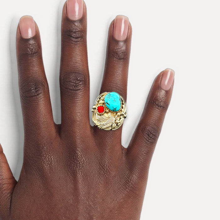 Native American Navajo Turquoise and Coral Bald Eagle Ring in Sterling Silver shown on a hand (deep skin tone)