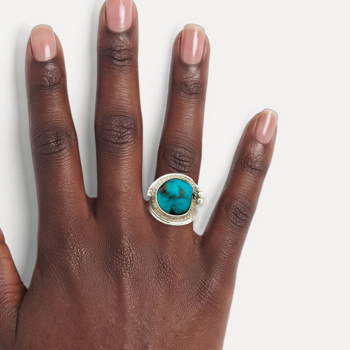 Deep Turquoise Cocktail Ring in Sterling Silver shown on a hand (deep skin tone)