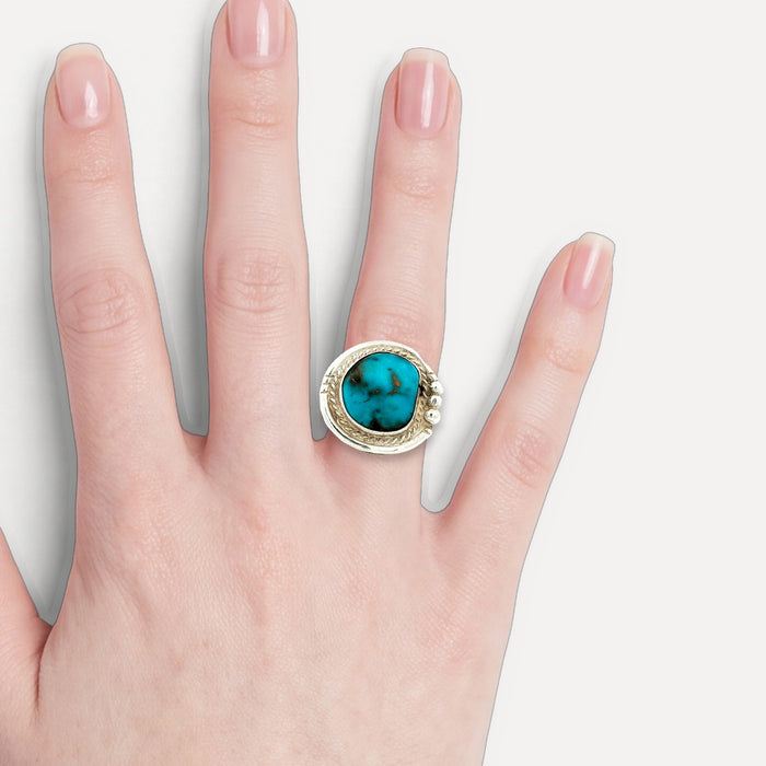 Deep Turquoise Cocktail Ring in Sterling Silver shown on a hand (light skin tone)