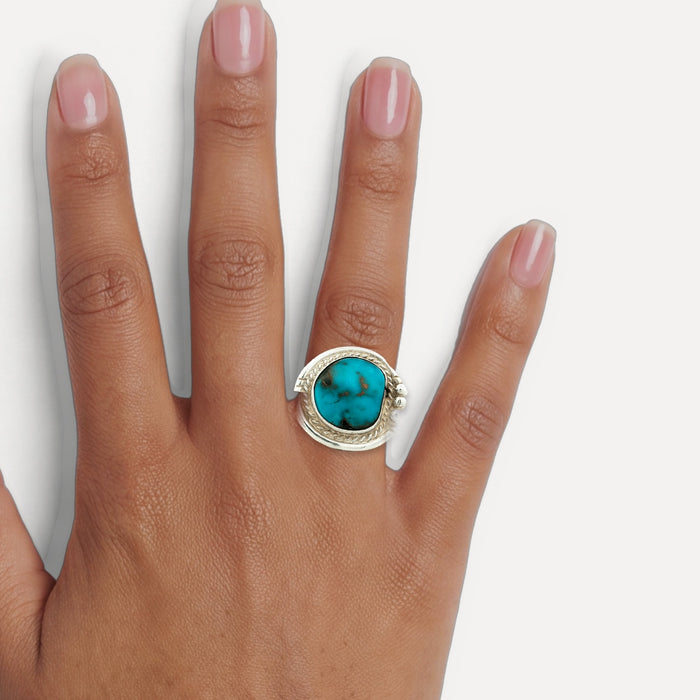 Deep Turquoise Cocktail Ring in Sterling Silver shown on a hand (medium deep skin tone)