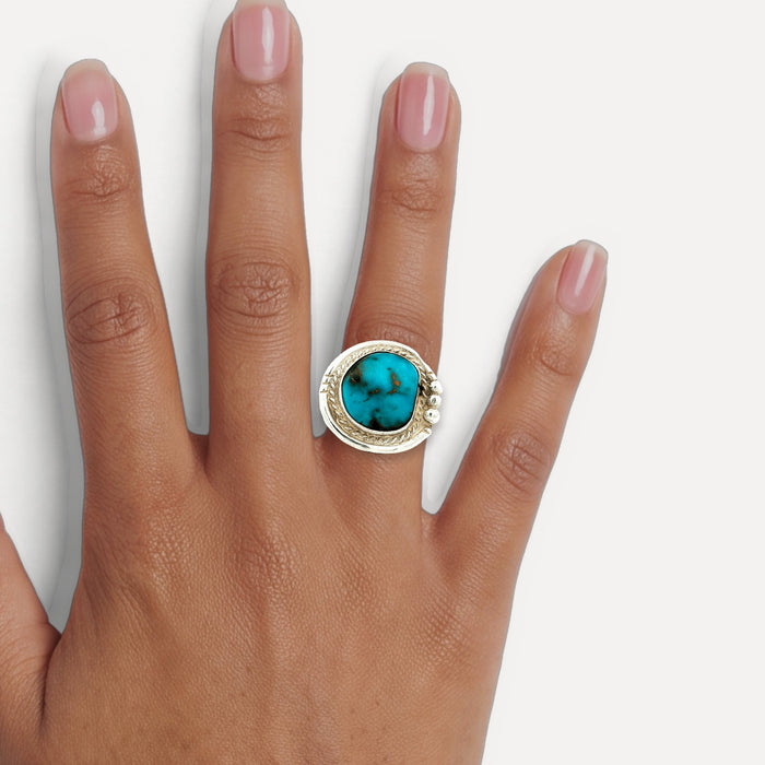 Deep Turquoise Cocktail Ring in Sterling Silver shown on a hand (medium deep skin tone)